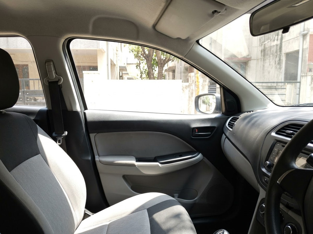 Dark vehicle glass and bodywork under workshop lighting