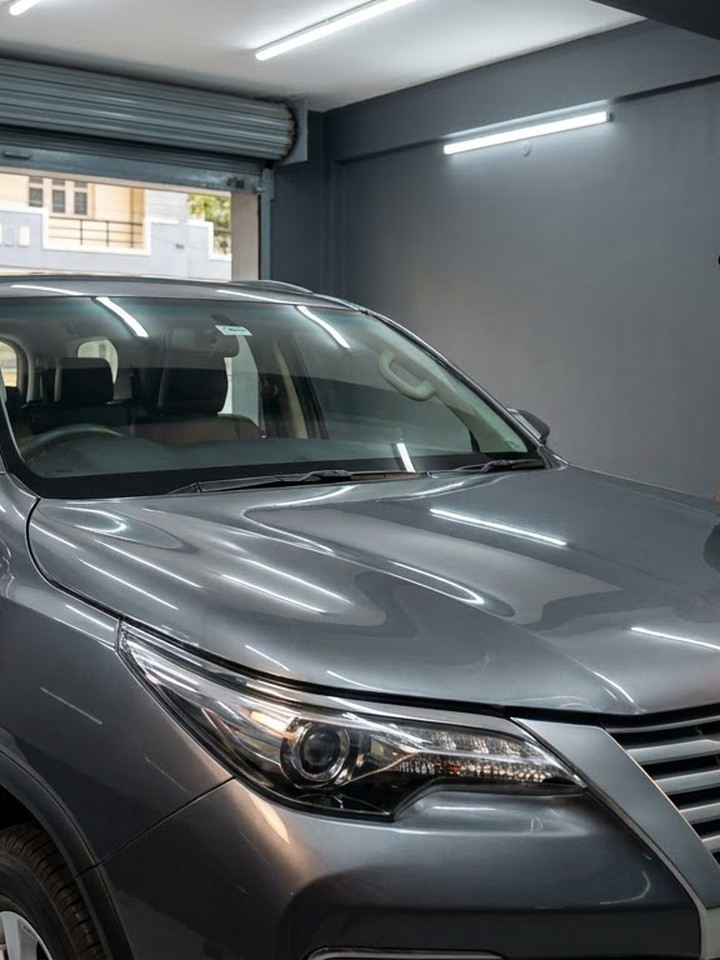 The same grey SUV with a clean, glossy film-protected front end